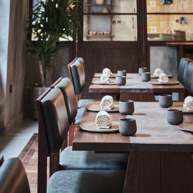 Inside dining area set tables at KOL