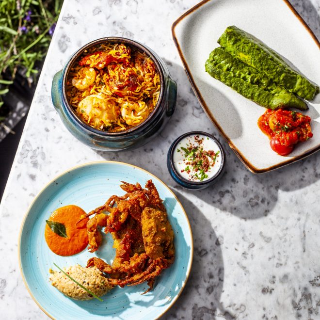 Cuisine served on plates on a marble table outdoors
