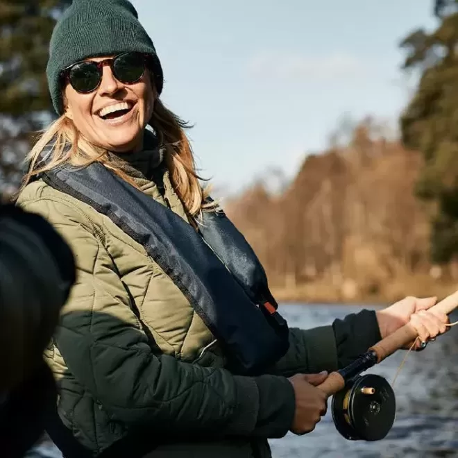 Women smiling and fishing at The Macallan, Speyside, Scotland