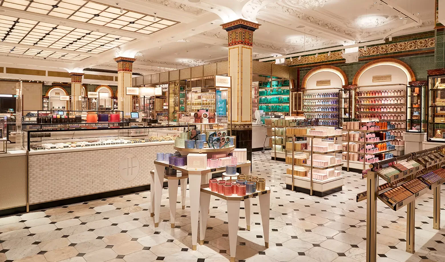 A luxurious cosmetics and fragrance store with elegant columns, ornate ceiling, tiled floor, and displays filled with colorful beauty products and perfumes. Bright lighting highlights the sophisticated decor.