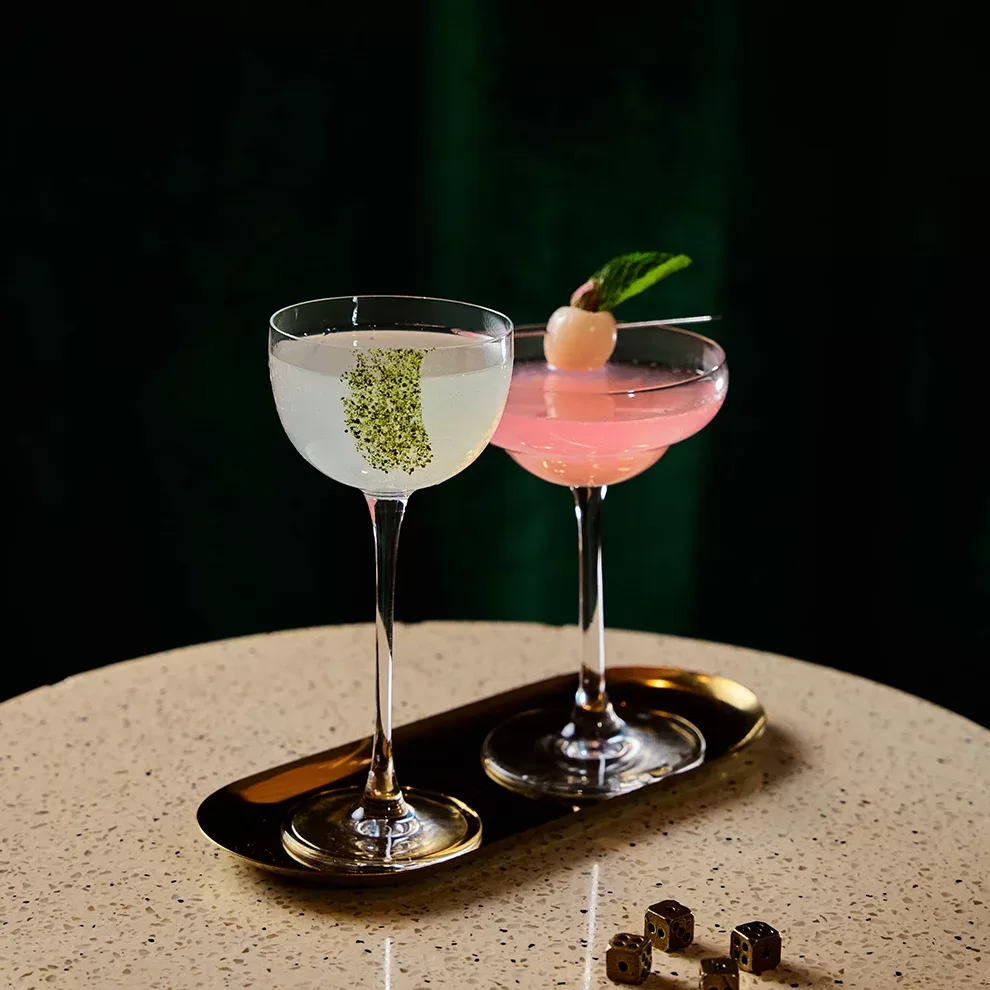Cocktails with garnish served in tall glasses on a tray at Veda at Ovolo Central, Hong Kong