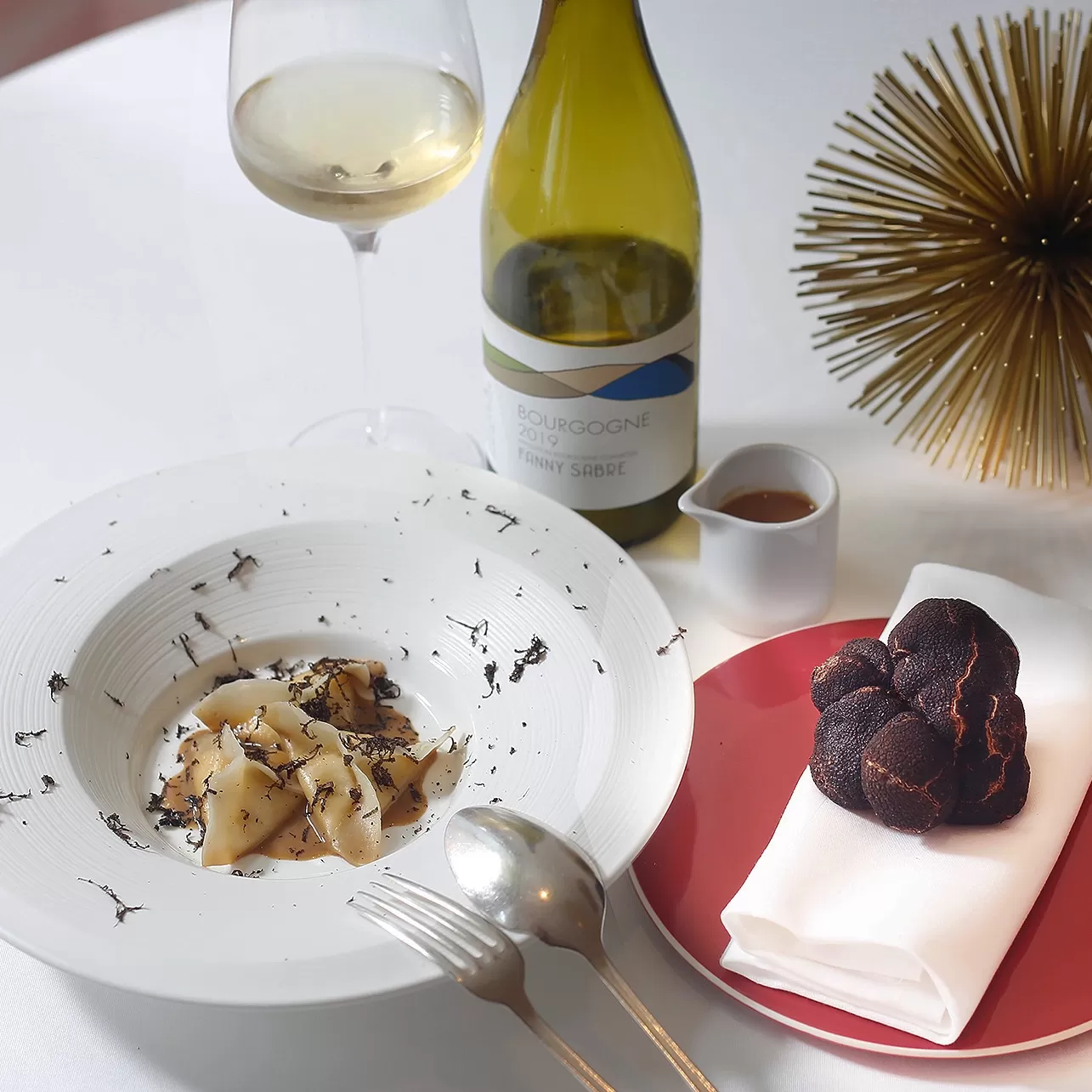 Luxury plant based dishes served in bowls served with white wine at Gauthier, Soho