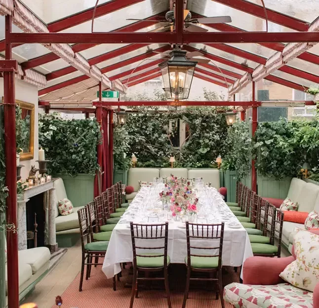 A cosy dining room in a London garden house, featuring elegant décor and natural light streaming through the windows.