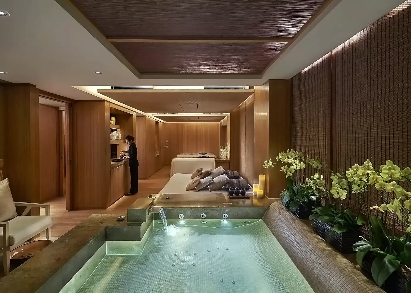 Inside luxury spa hot tub, queen size lounge bed and treatment beds