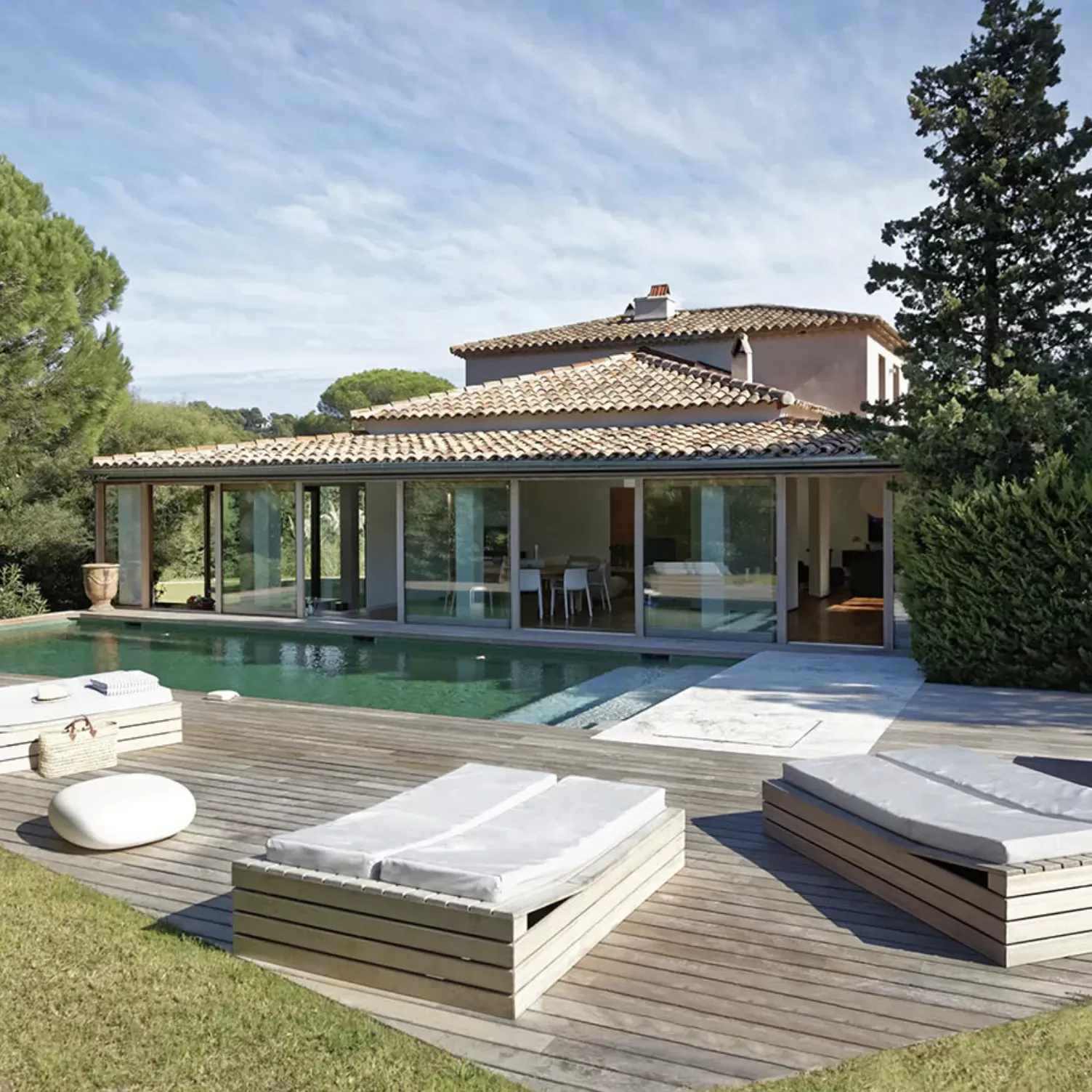 Outside view of luxury home with outdoor pool and sunbeds in St Topez