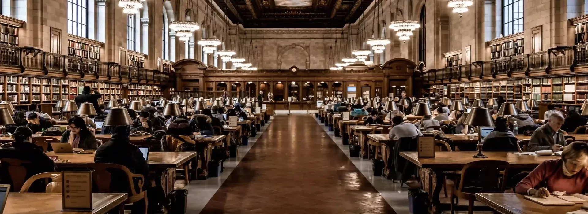 Walkway through grand luxury interior library with people seated left and right sides of walkway