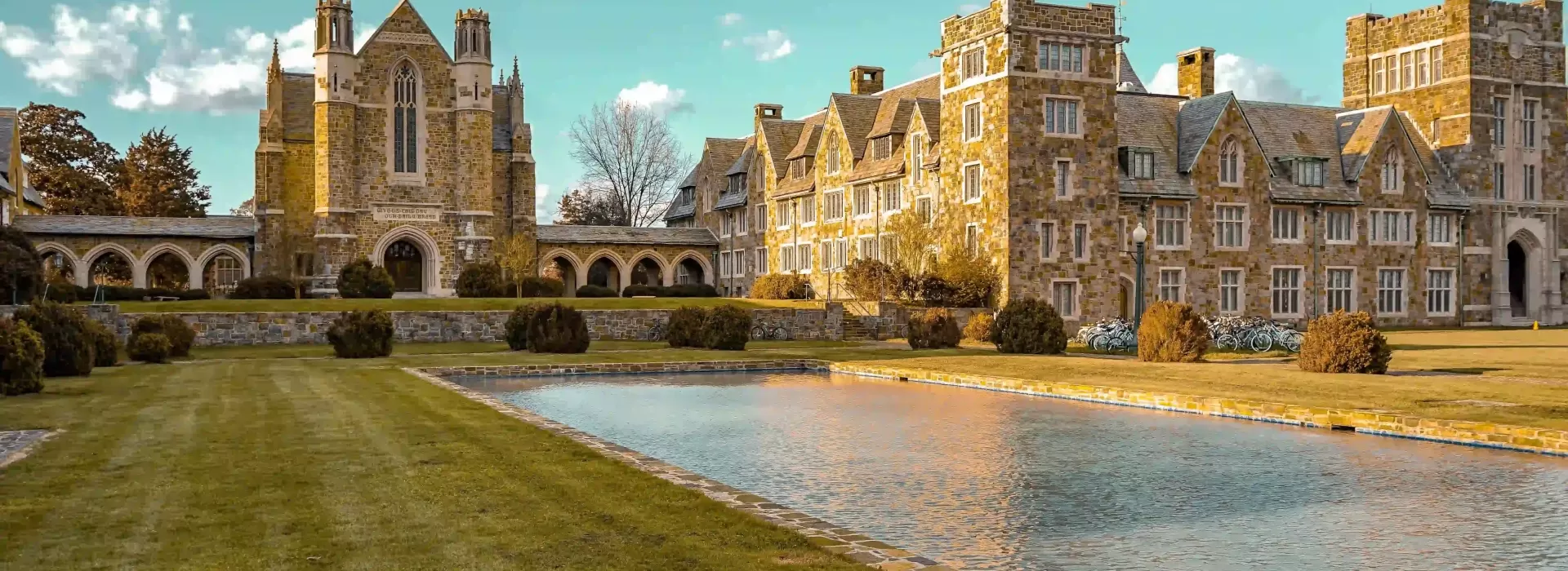 Large and old grand outside building with pond