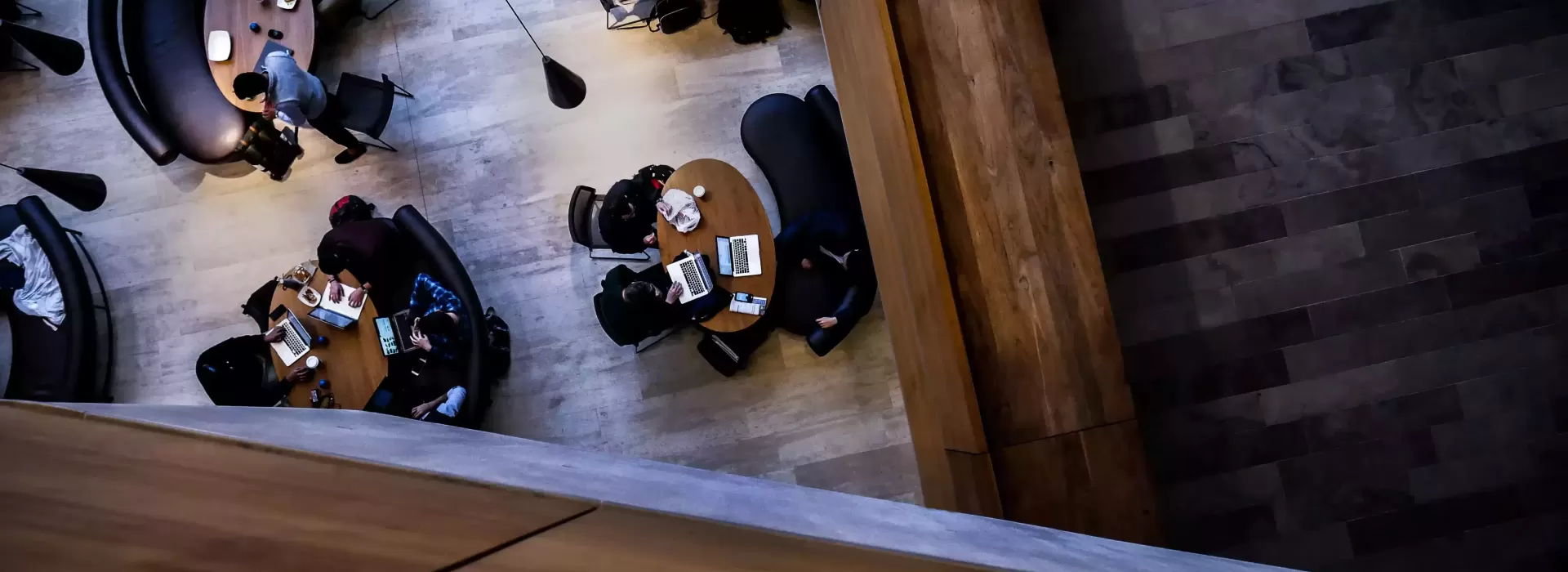 Birdseye view of people sat at round tables in a library