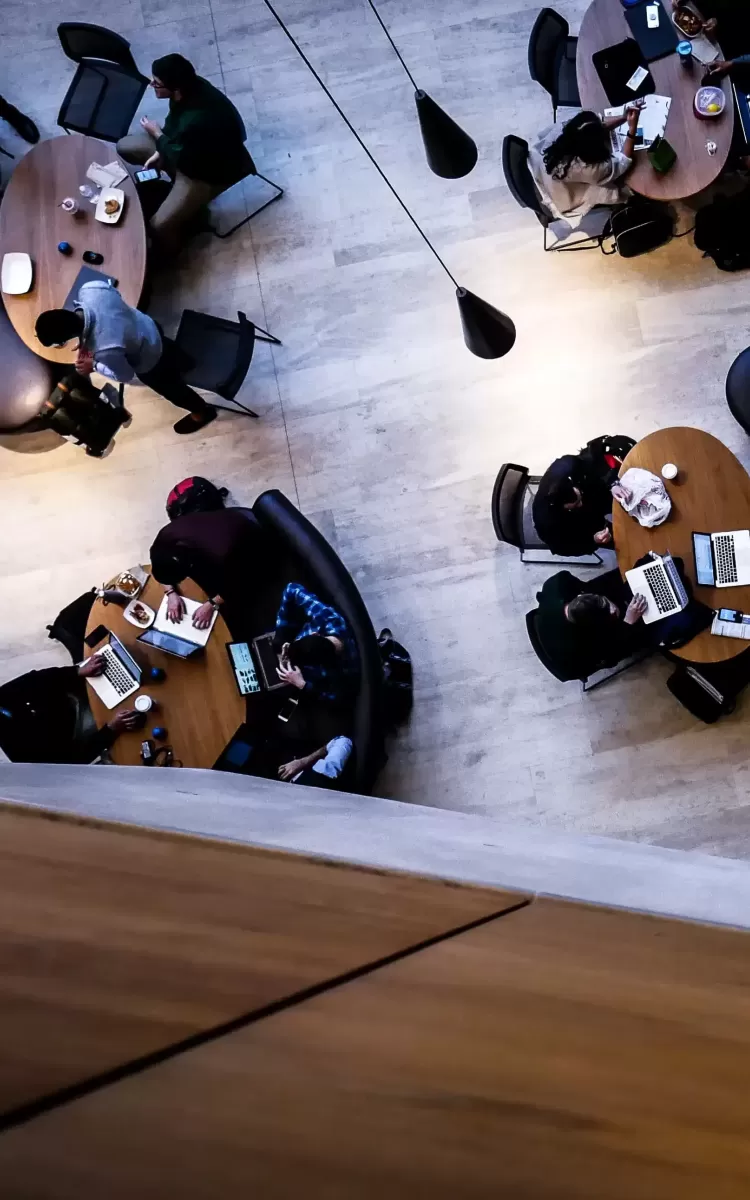 Birdseye view of people sat around tables in a library